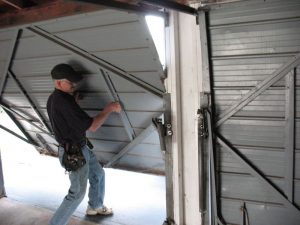 A garage door repair Minnesota expert double checks a repair